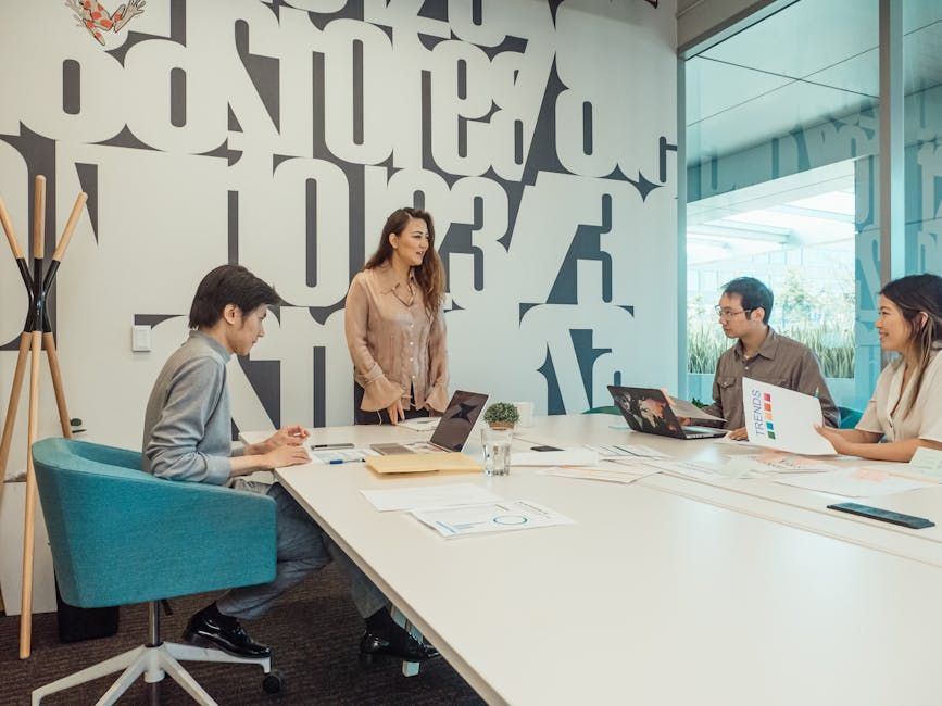Diverse team engaged in brainstorming session in a modern office space.